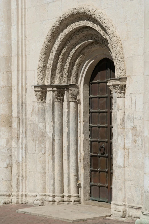 a red fire hydrant sitting in front of a building, an album cover, romanesque, conversano, arched doorway, silver，ivory, close - up photograph