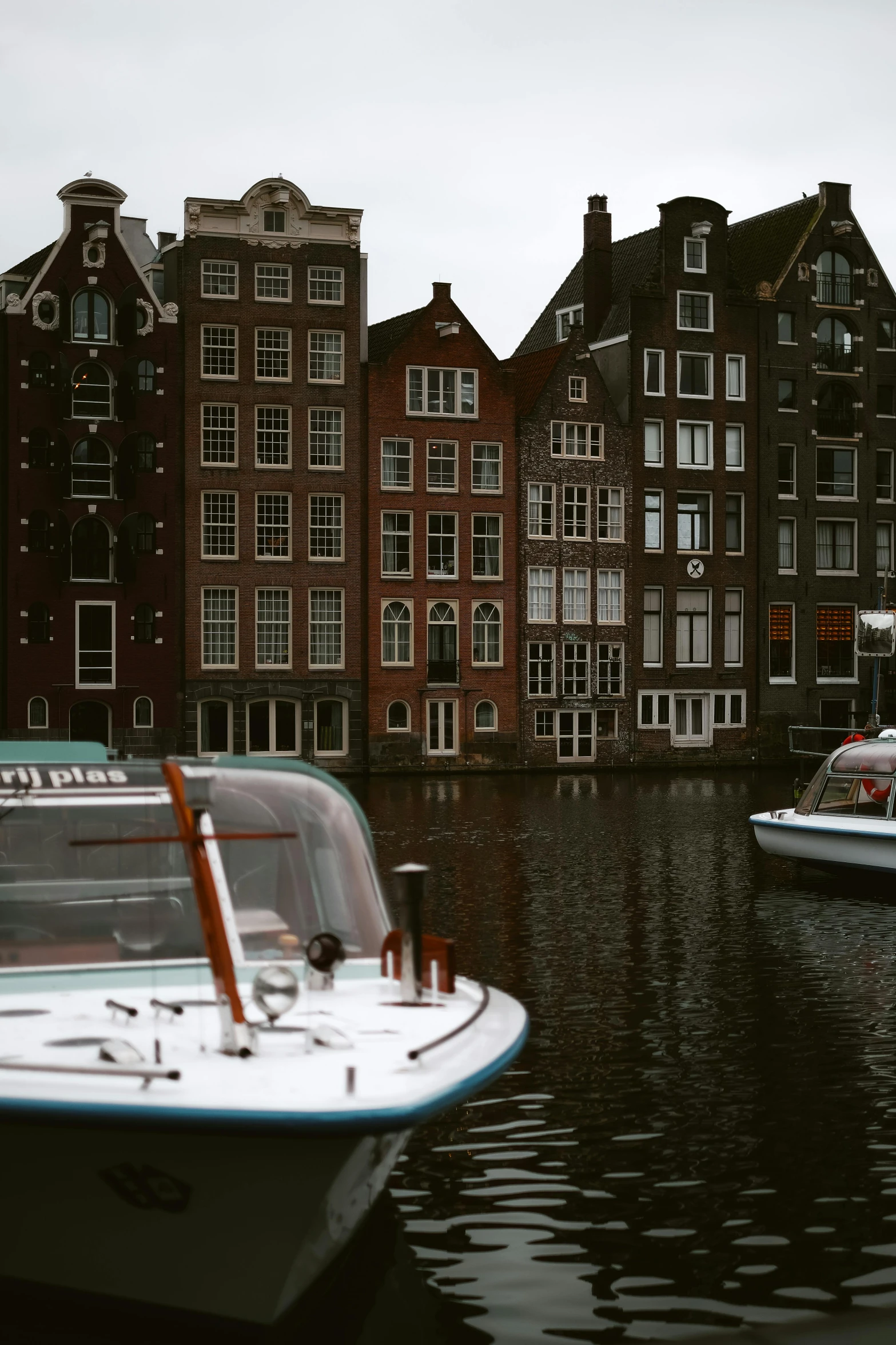 a couple of boats that are in the water, by Jan Tengnagel, pexels contest winner, art nouveau, small buildings, dutch style, low quality photo, 4 k cinematic still