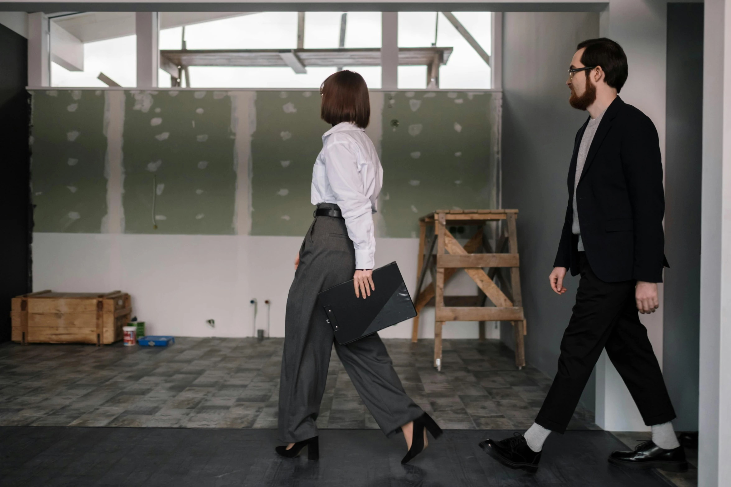 a man and a woman walking in a room, pexels contest winner, modernism, black suit pants, working clothes, full body image, charli bowater and artgeem