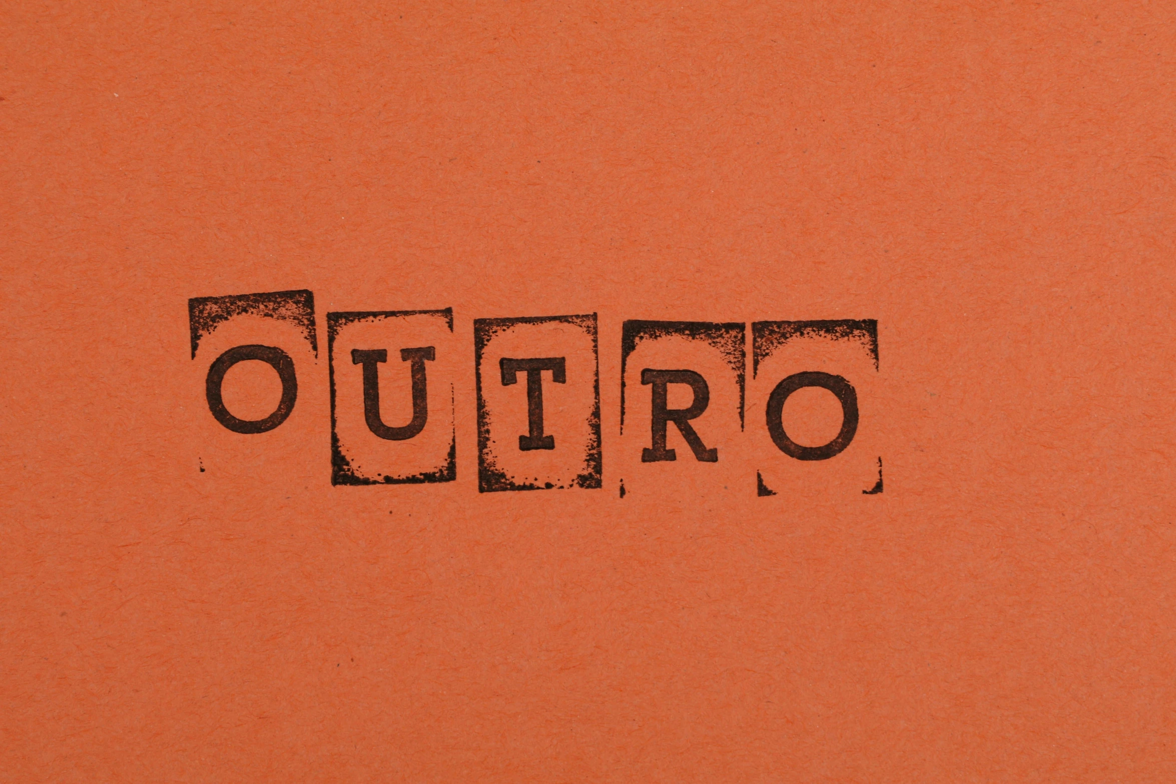 a close up of a piece of paper with the word outro written on it, an album cover, inspired by Christo, quito school, burnt sienna, retro games, lino print, no - text no - logo