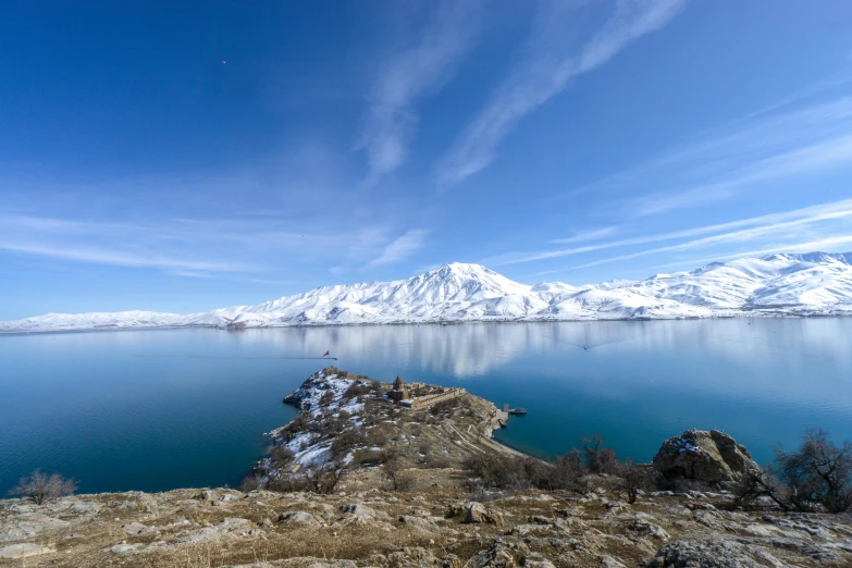 a po taken of the landscape of mountains, blue water and snow - capped mountains