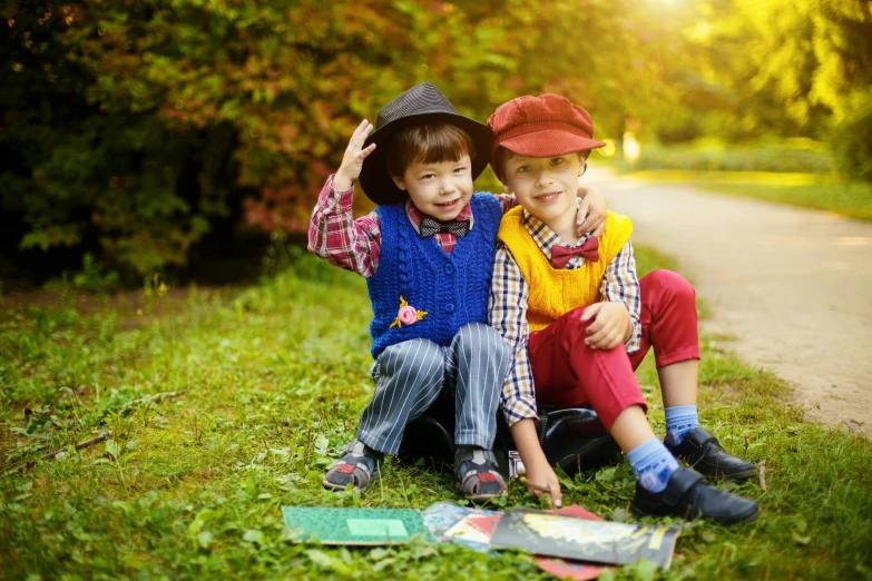 two young boys sitting next to each other on the grass, a picture, by Julia Pishtar, pixabay, visual art, wearing a french beret, 3 are summer and 3 are autumn), 15081959 21121991 01012000 4k, costume