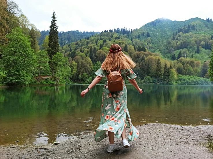 a woman with a backpack walking along the shore of a lake, pexels contest winner, renaissance, excited russians, lush surroundings, 😭 🤮 💕 🎀, carpathian mountains