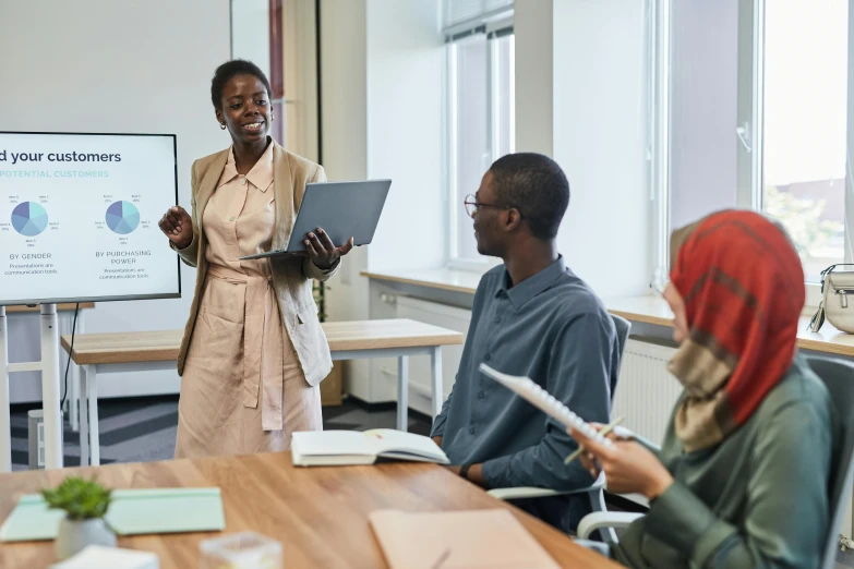 a woman giving a presentation to a group of people, by Carey Morris, pexels contest winner, riyahd cassiem, sat in an office, teacher, profile image