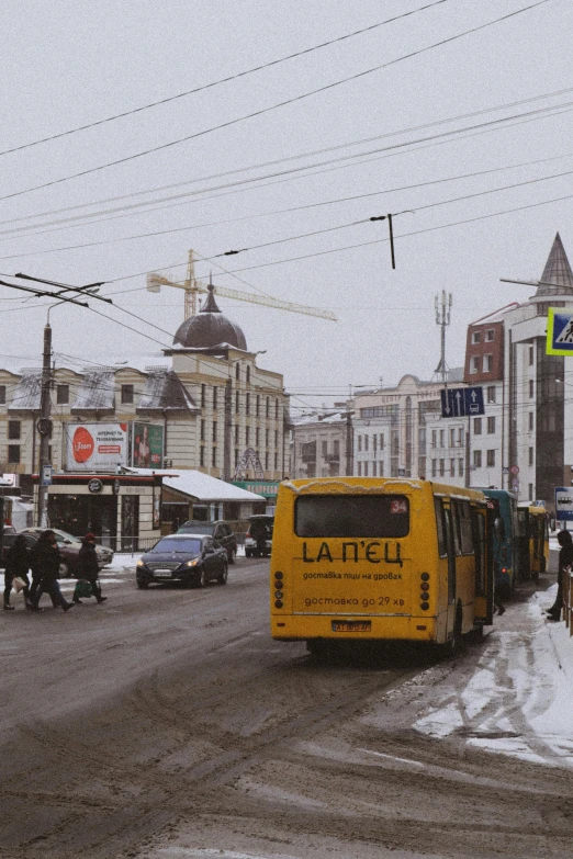 several vehicles and horses in the snow on the street