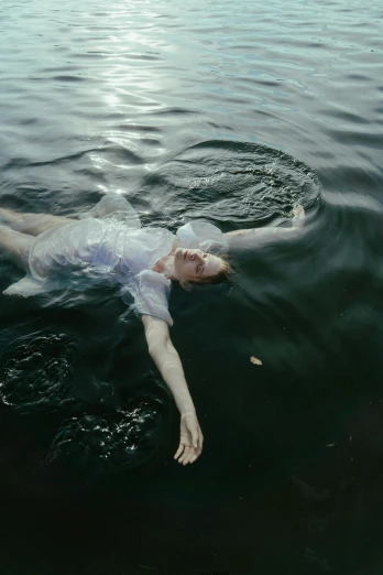 a person swimming in a body of water, inspired by Brooke Shaden, pexels contest winner, renaissance, autochrome pearl portrait, still from a music video, floating ghost, 1960s color photograph