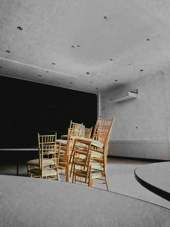 a black and white photo of a dining room, an album cover, by Lucia Peka, unsplash, theater stage, colorized, gold, classroom