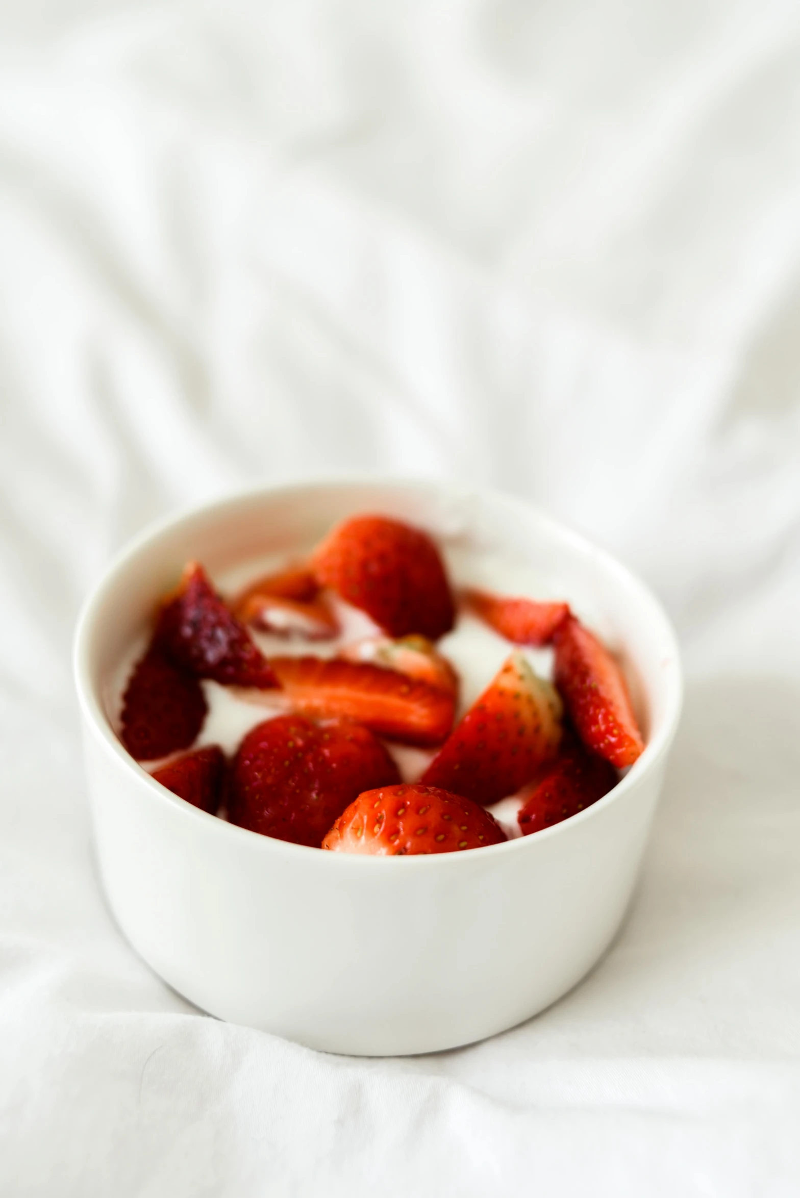 a bowl of yogurt with strawberries in it, unsplash, dau-al-set, white backdrop, low detail, morning glow, made of glazed