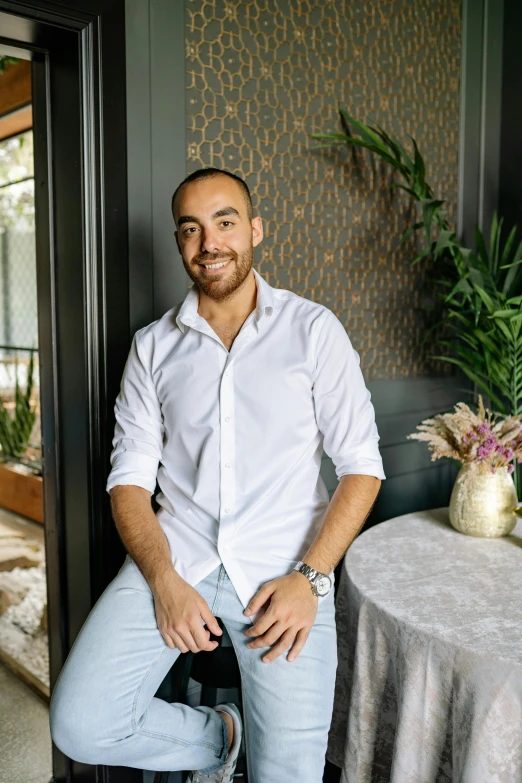 a man sitting on a chair in front of a table