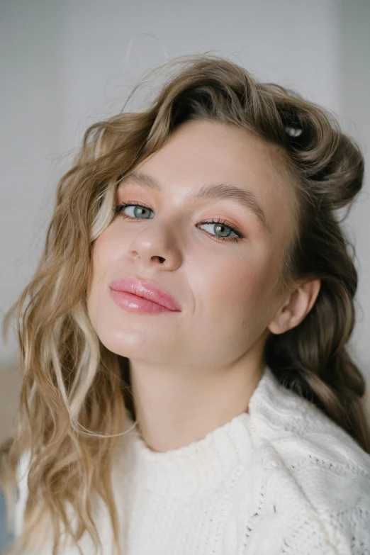 a woman in a white sweater posing for a picture, inspired by Louisa Matthíasdóttir, trending on pexels, light pink lipstick, sydney sweeney, curls, high light on the left