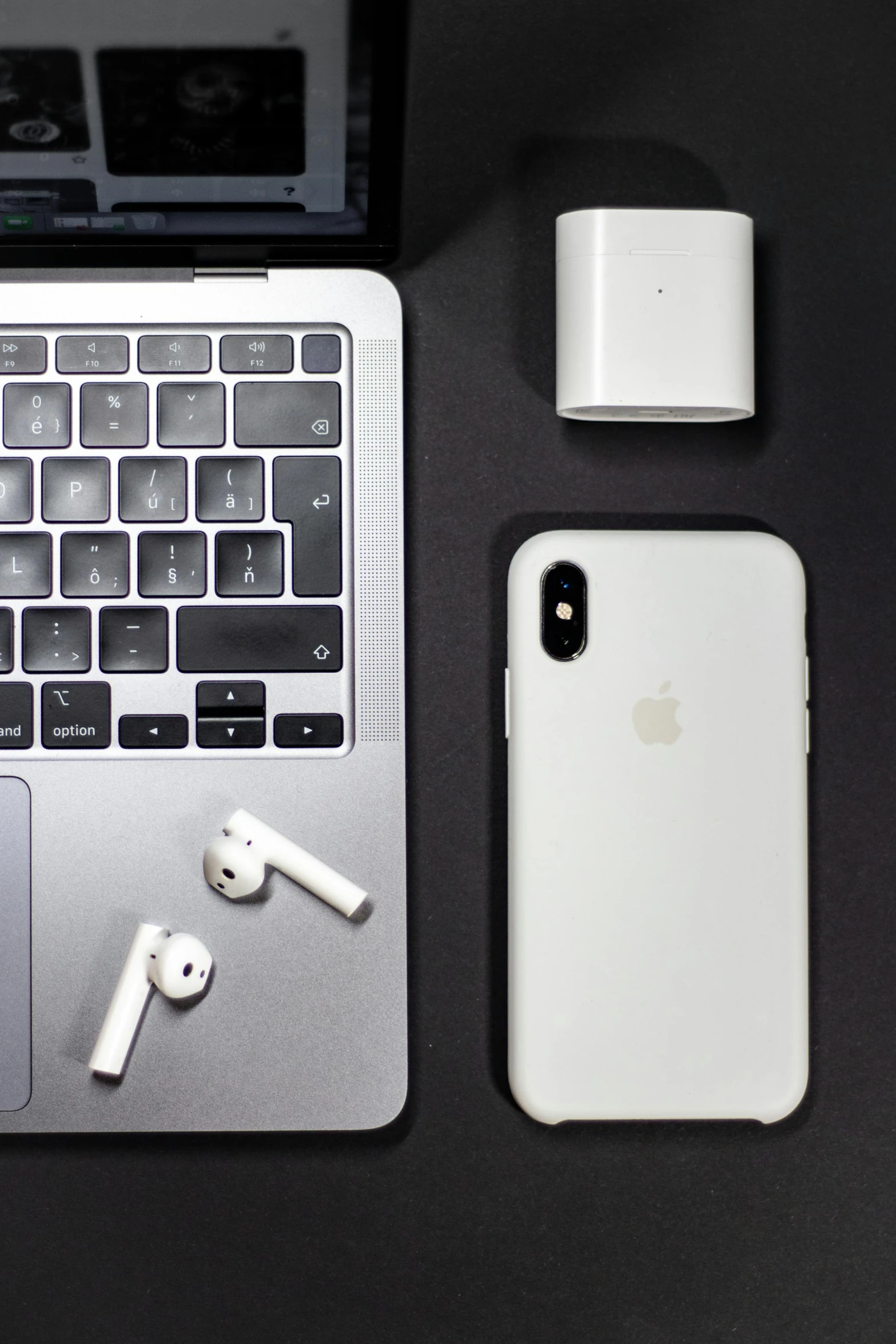 an open laptop computer sitting on top of a desk, pexels, minimalism, airpods, 2 5 6 x 2 5 6, silicone cover, captured on iphone