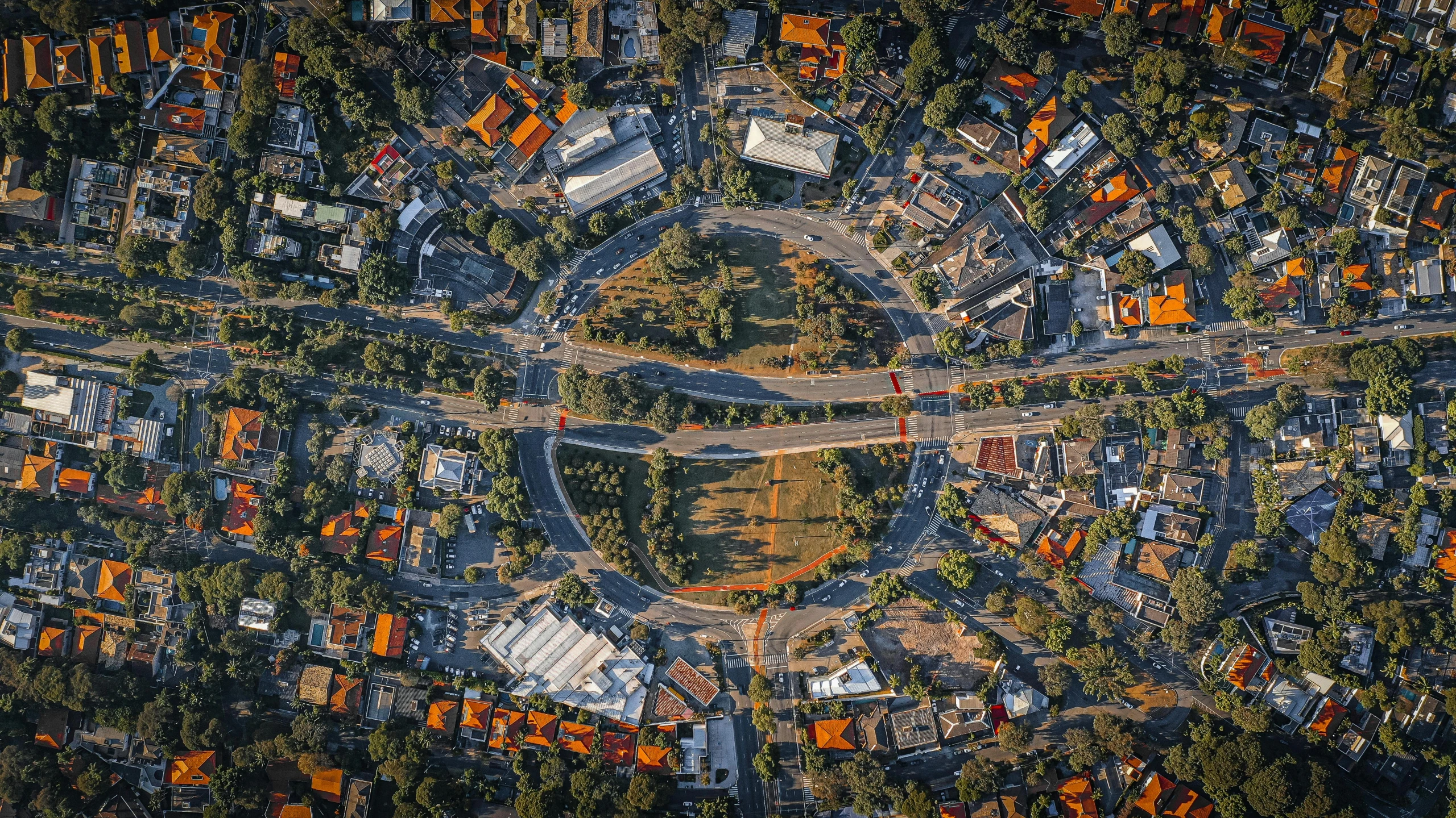 an aerial view of a city with lots of buildings, by Lee Loughridge, unsplash contest winner, renaissance, caulfield, circle forms, suburban, streetscapes