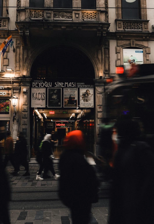 a group of people walking in front of a building, by Micha Klein, pexels contest winner, broadway, busy night, [ theatrical ], underground