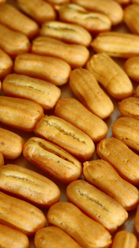 a tray of cookies sitting on top of a table, inspired by Károly Patkó, hurufiyya, hot dog, reuters, brazil, alien capsules