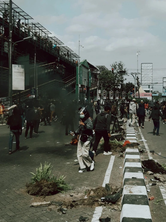 a group of people standing on the side of a road, by Kogan Gengei, pexels contest winner, auto-destructive art, tear gas, south jakarta, instagram story, aftermath of a huge battle