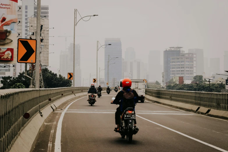 a group of people riding motorcycles across a bridge, pexels contest winner, jakarta, avatar image, dusty street, background image