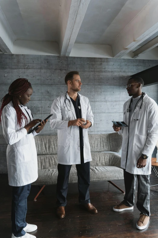 a group of doctors standing next to each other, pexels, renaissance, dark people discussing, tech robes, white, a wooden