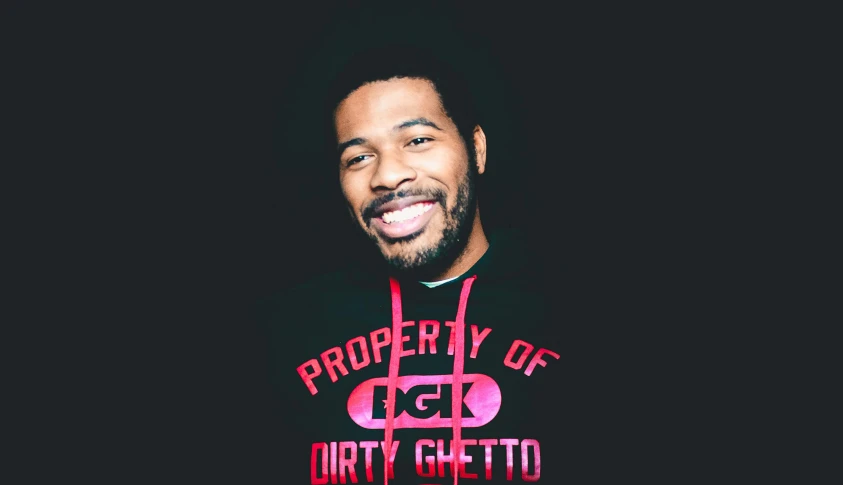 a man with a beard standing in front of a black background, an album cover, by Stokely Webster, graffiti, teeth gritted, dirt stains, promotional image, looking cute