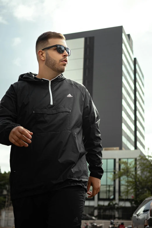 a man in a black jacket and sunglasses walking down a street, addidas, thumbnail, gang clothing, plus-sized