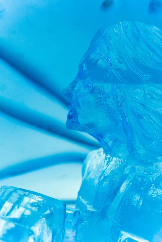 a blue - colored, artistic glass sculpture that appears to have been made with plastic