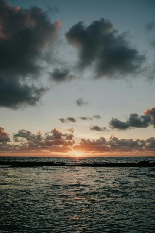 the sun is setting over the ocean on a cloudy day, unsplash, reunion island, video, 8k octan photo