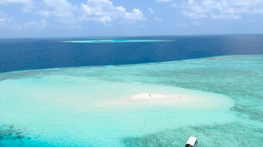 an aerial view of a boat and water,