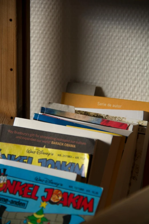 a bunch of books sitting on top of a shelf, hotel room, comics, brown