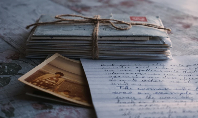 a stack of old letters sitting on top of a table, a portrait, unsplash, fan favorite, delicious, instagram photo, romantic lead