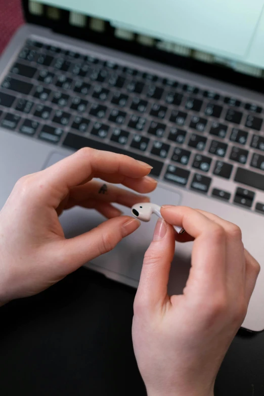 a close up of a person typing on a laptop, airpods, thumbnail, haunted, item