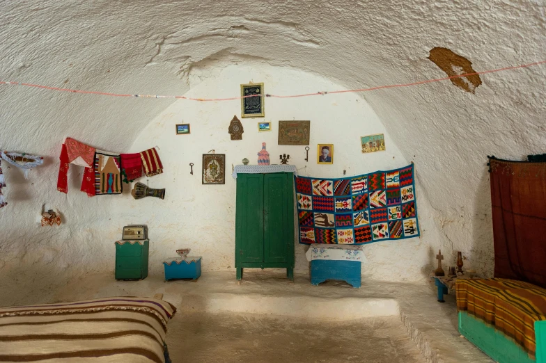 a bedroom that has a bed in it, an album cover, by Riad Beyrouti, unsplash contest winner, cave system, inside house in village, taken in the early 2020s, textiles