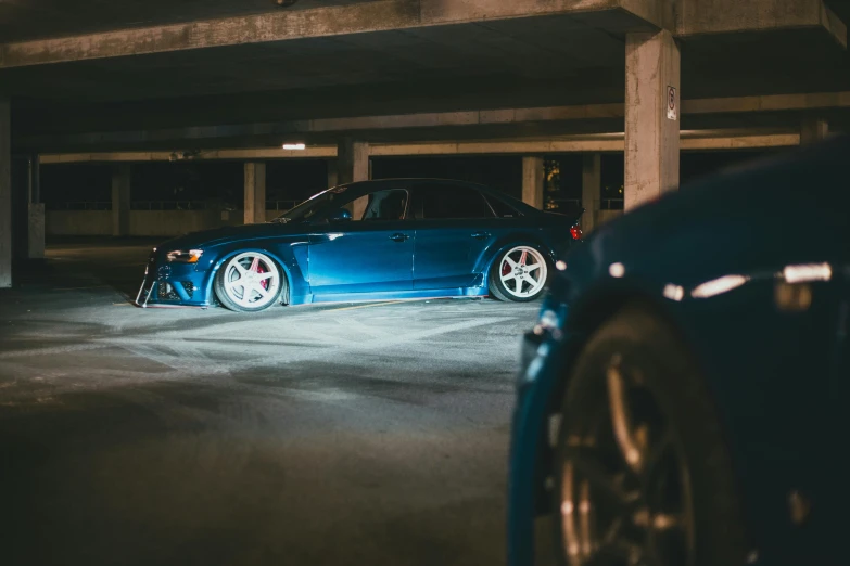 a blue car parked in an underground garage
