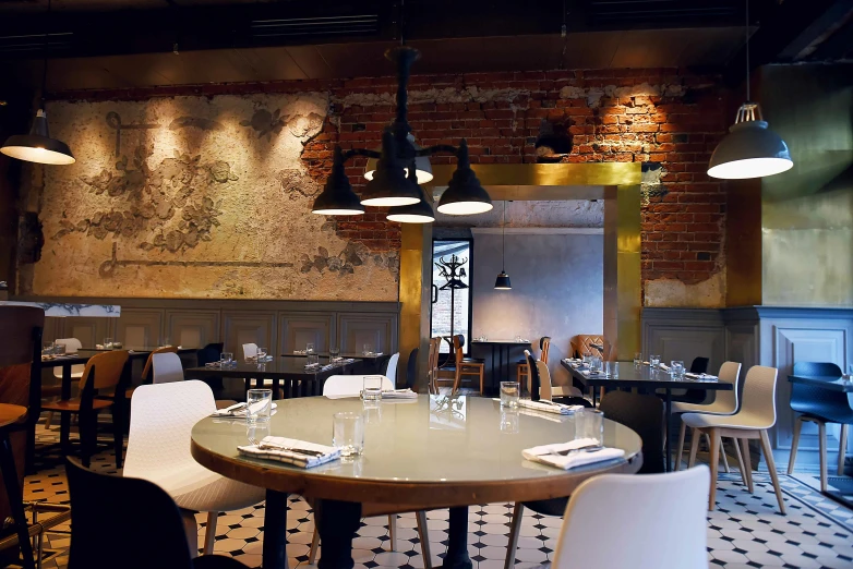 large dining room with tables and several hanging lights