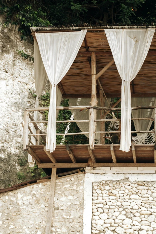 an old building is decorated with white curtains