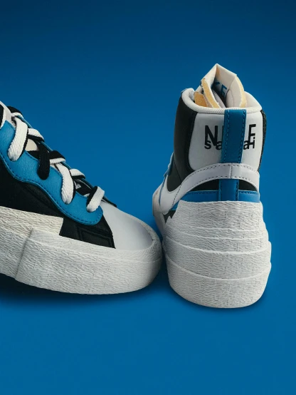a pair of high - top sneakers with white, black and blue trims