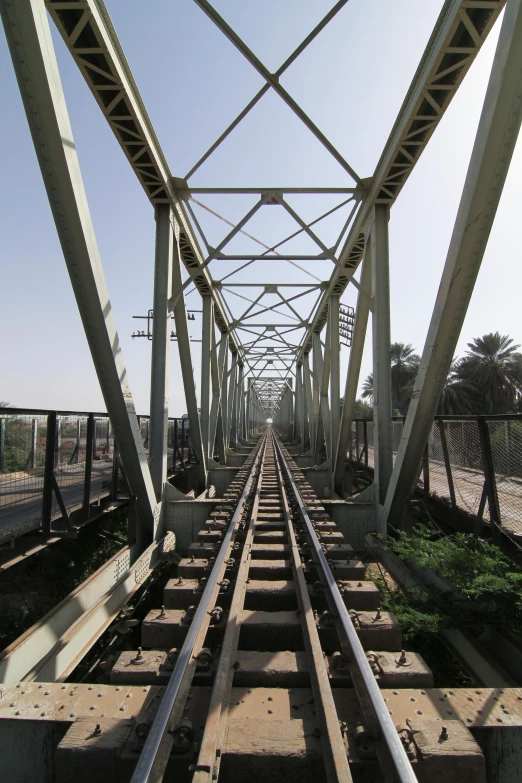 there is a train track that is going under a bridge