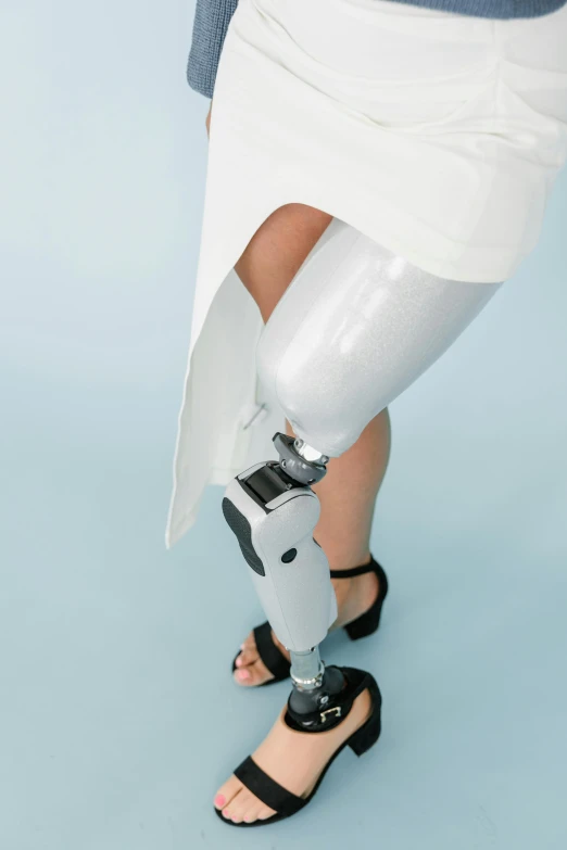 a woman with a prosthetic device on her leg, by Daniel Taylor, white metallic, high angle, jen atkin, lightweight