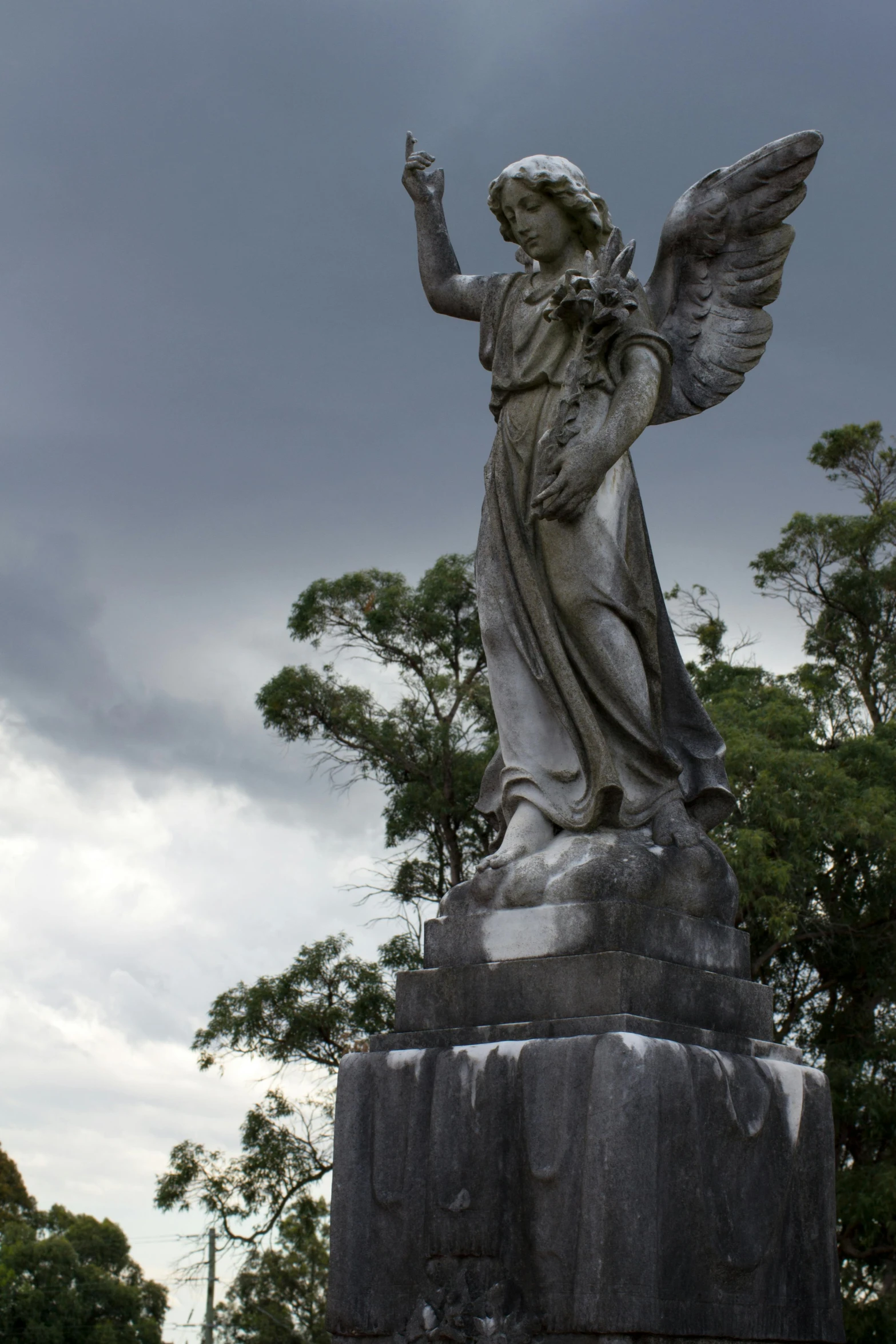 a statue of an angel in a cemetery, inspired by Carel Willink, baroque, ominous skies, coban, buenos aires