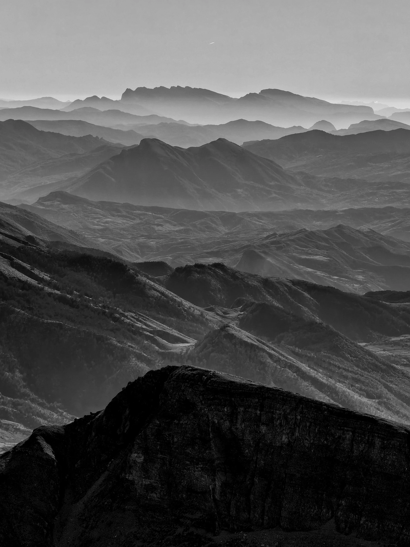 view from the top of a mountain with hills in the background