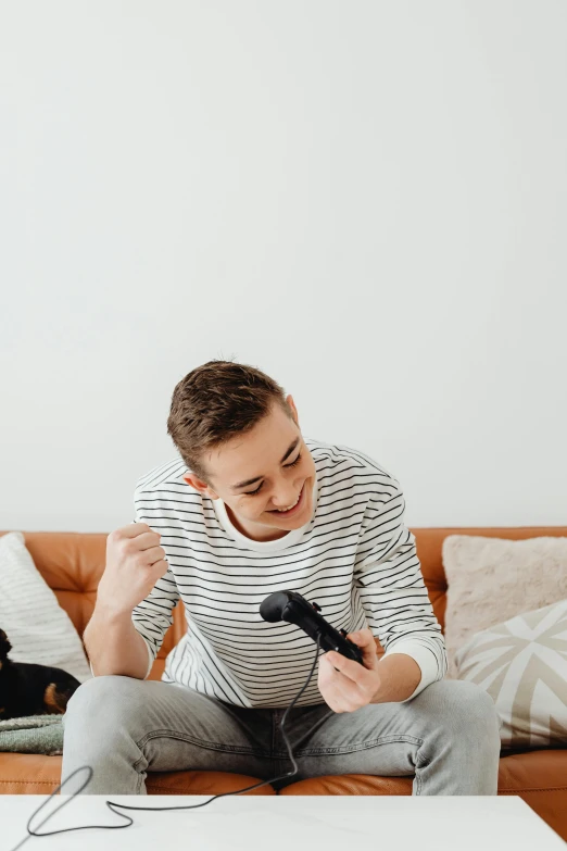 a man sitting on a couch playing a video game, an album cover, pexels contest winner, happening, singing into microphone, happy kid, an epic non - binary model, on grey background