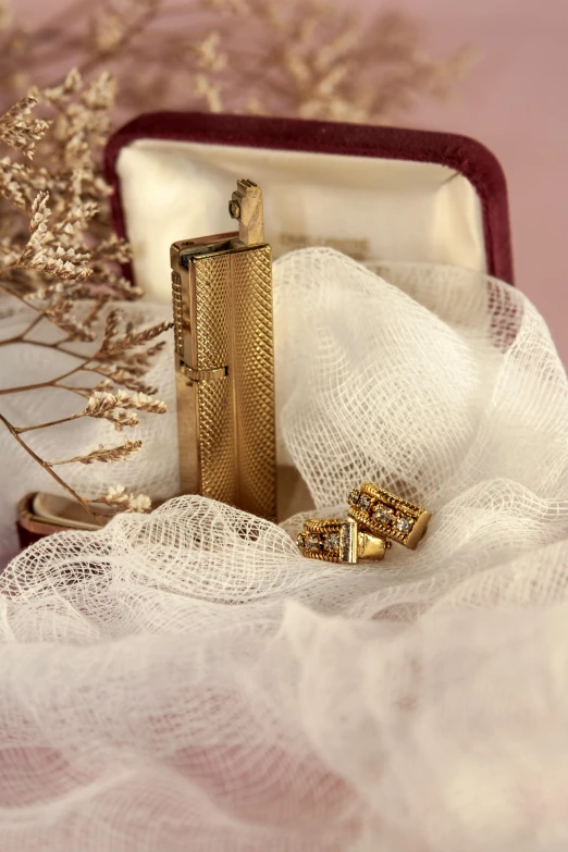 a close up of a wedding ring in a box, inspired by Eliseu Visconti, lockpicks and pile of gold, 1 9 2 0 s cloth, gold earring, photograph taken in 2 0 2 0