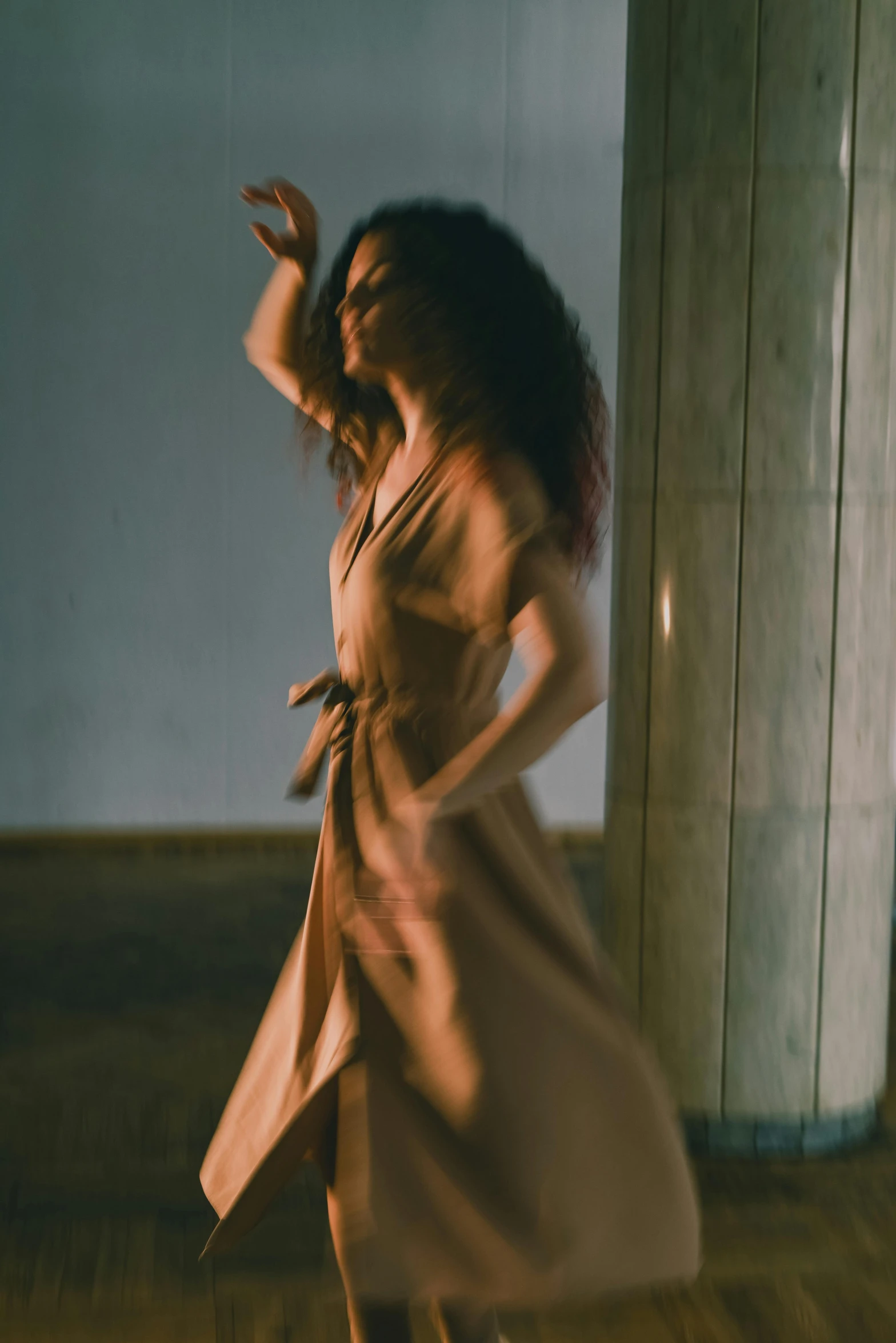 a woman in a dress is dancing in a room, inspired by Nan Goldin, pexels contest winner, renaissance, muted brown, promotional image, silk robes, a woman walking