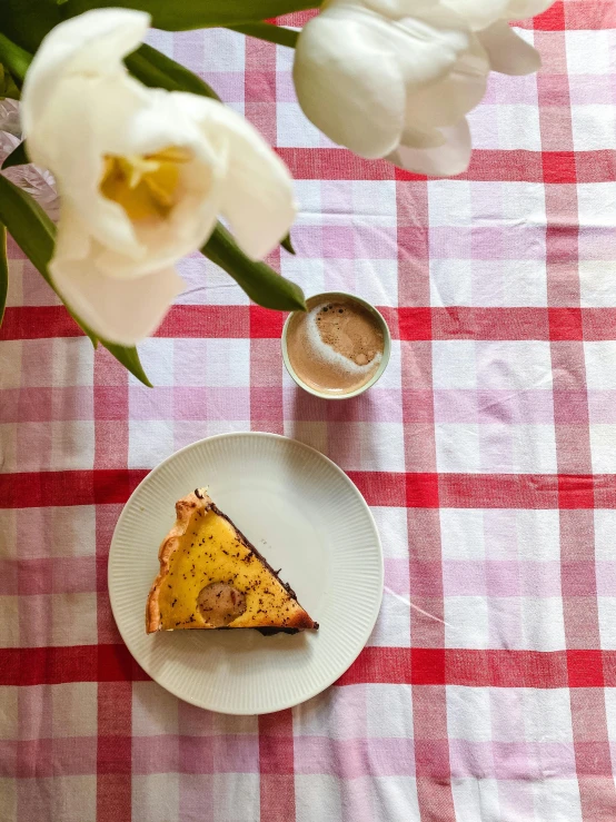 a close up of a plate of food on a table, a portrait, by Lucia Peka, shutterstock contest winner, romanticism, tablecloth, tulip, bakery, yellow