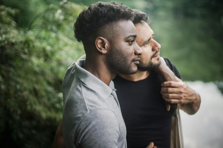 a couple of men standing next to each other, trending on pexels, lgbtq, essence, embraced, ignant