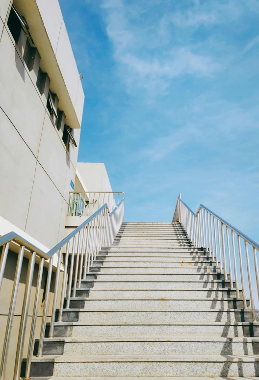 a set of stairs leading up to a building, by Niko Henrichon, unsplash, hypermodernism, clear blue sky, square, schools, evan lee