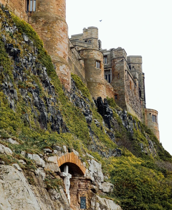 a large castle sitting on top of a lush green hillside, an album cover, by Thomas Furlong, pexels contest winner, 2 5 6 x 2 5 6 pixels, stonework, cliffside, holy