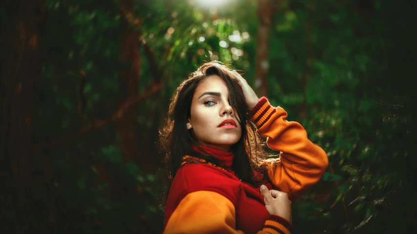 a woman standing in the middle of a forest, inspired by Elsa Bleda, trending on pexels, aestheticism, innocent look. rich vivid colors, brunette woman, vibrant orange, instagram post
