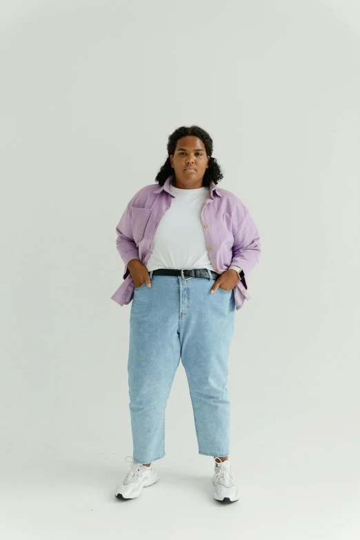 a woman posing in a purple and white jacket