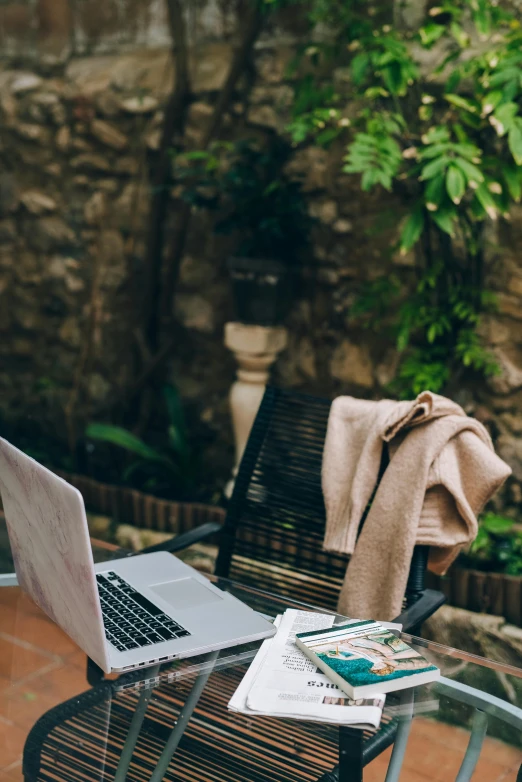 a laptop computer sitting on top of a glass table, unsplash, renaissance, sitting in the garden, casually dressed, banner, patio