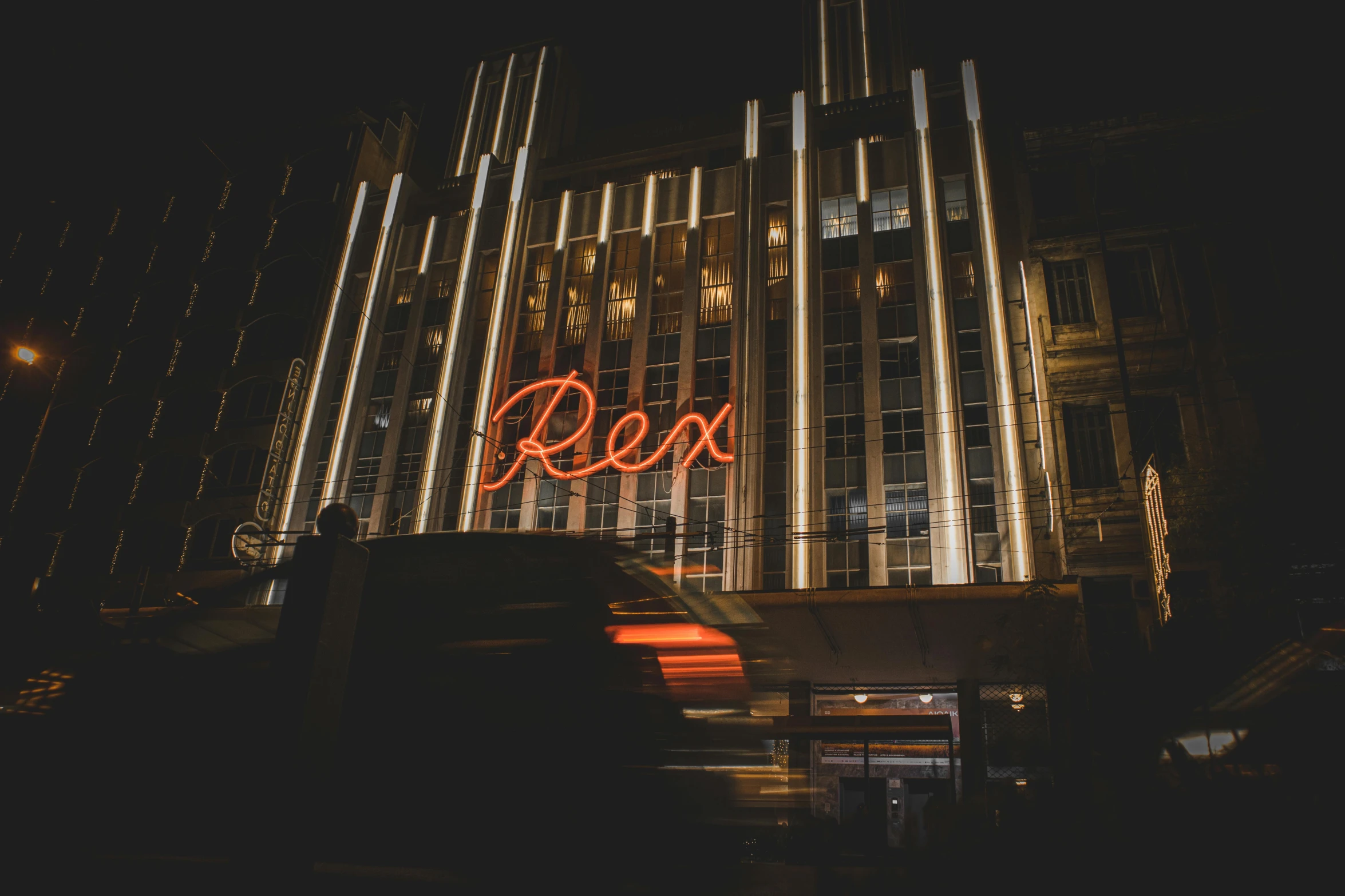 the neon sign is located near a building