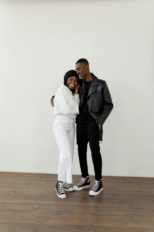 a man and a woman standing in an empty room, trending on unsplash, visual art, wearing white sneakers, smiling couple, adut akech, casual black clothing